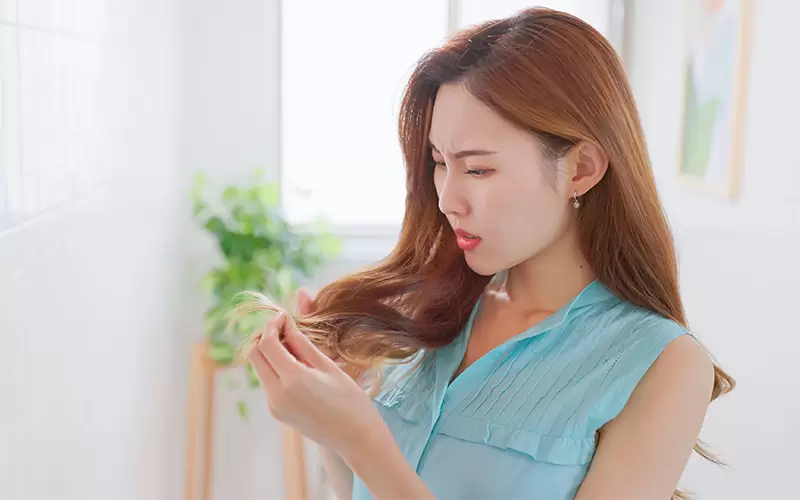 Asian woman has damaged hair