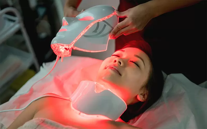Beautiful woman at the spa getting a facial laser treatment
