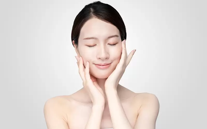Woman Touching Face with Relaxed Expression