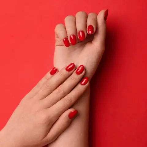 Woman,With,Gel,Polish,On,Nails,Against,Red,Background,,Top
